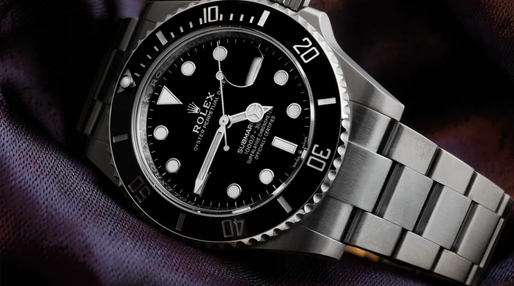 Submariner style dive watch with black dial and rotating bezel on wrist